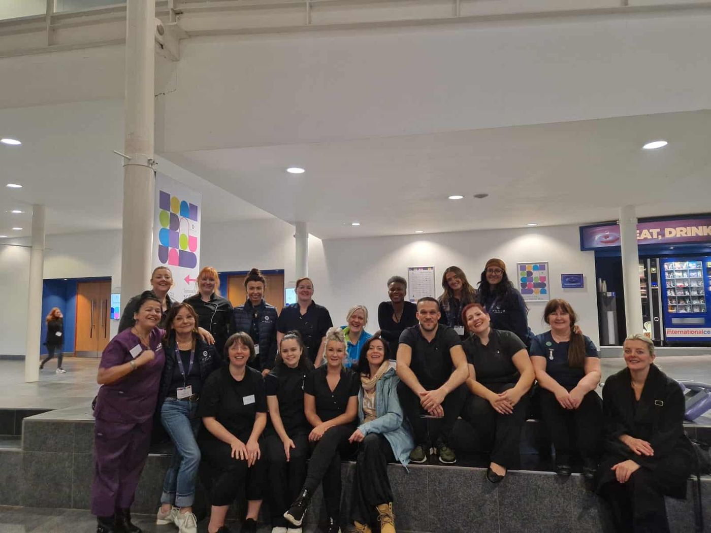 The team of therapists gathered on the steps at Telford International Centre